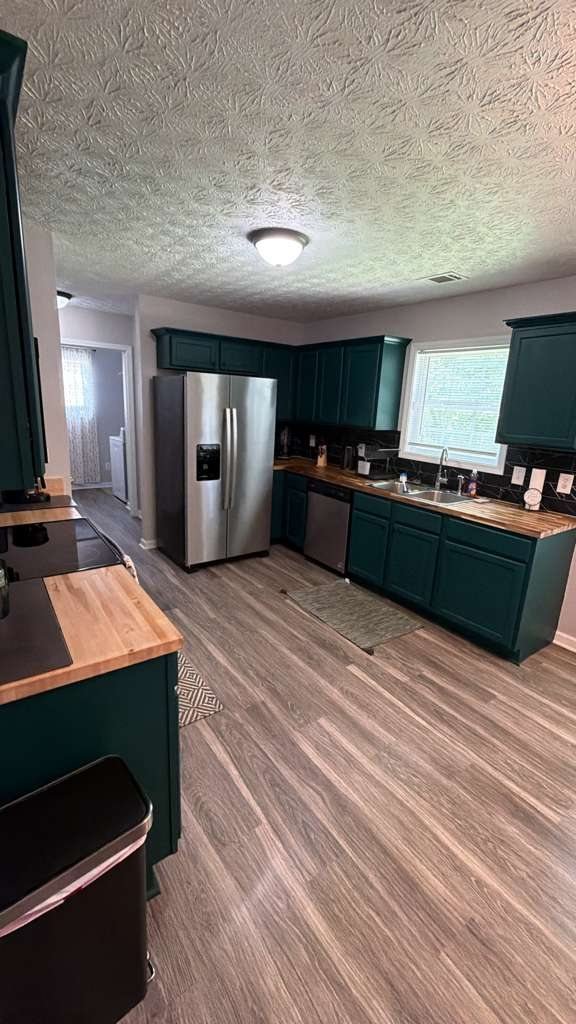 Cleaned kitchen with green cabinets